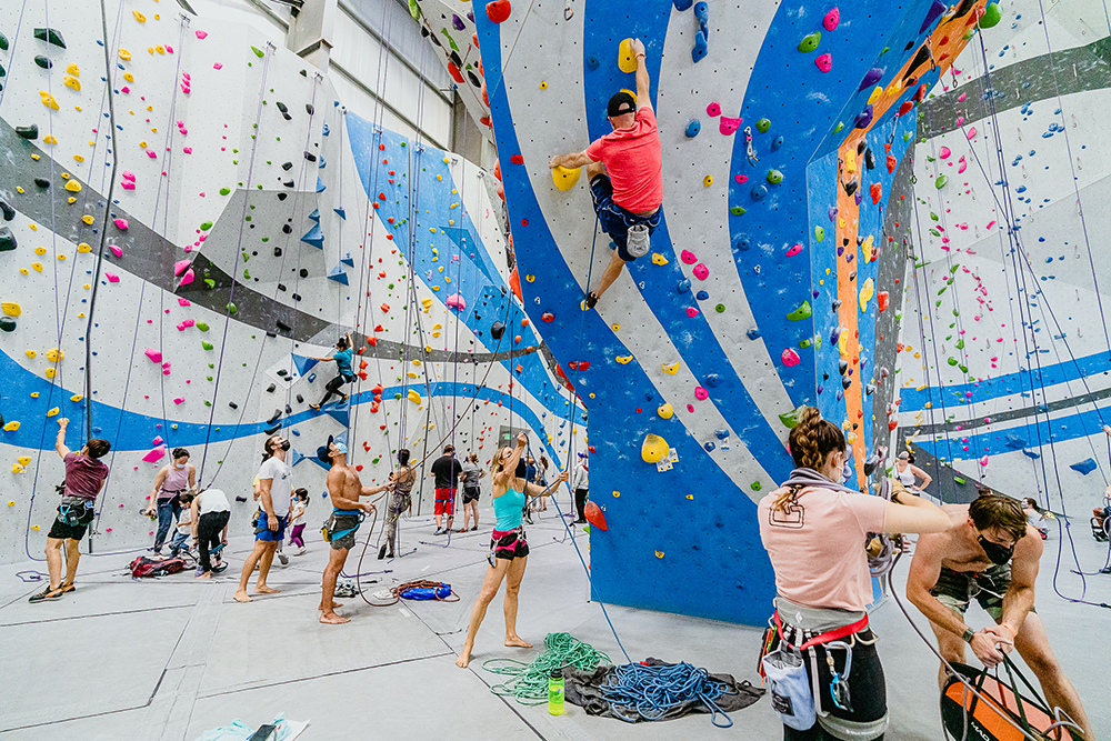 Groups rope climbing together