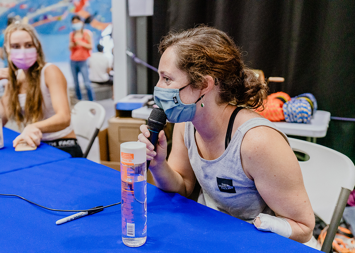 Pro Climber, Maureen Beck, talks into a microphone during a live Q & A on Global Climbing Day.