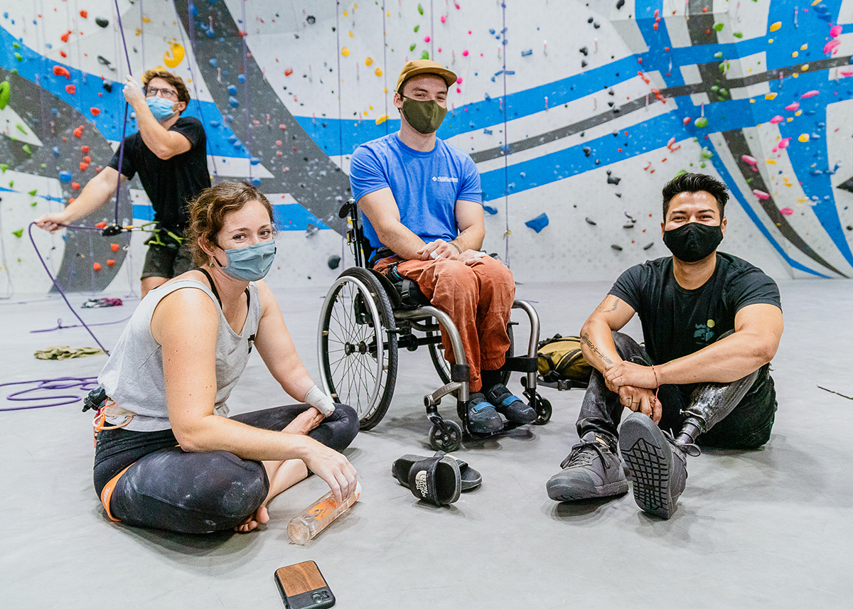 Pro climber, Maureen Beck, sits with two other paraclimbing athletes at Sender One LAX on Global Climbing Day.
