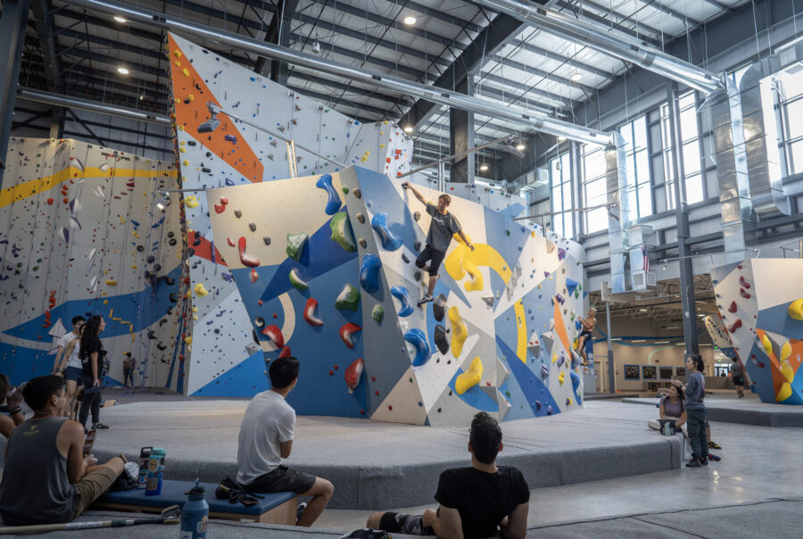 Group of people climbing a bouldering wall
